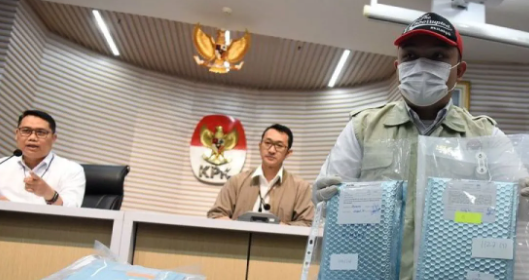 Plt Deputi Penindakan dan Eksekusi KPK Asep Guntur Rahayu (kiri) bersama Juru Bicara KPK Budi Prasetyo (tengah) menyaksikan petugas KPK menunjukkan barang bukti kasus dugaan korupsi pengadaan mesin electronic data capture (EDC) Bank Rakyat Indonesia (BRI). Foto: Istimewa